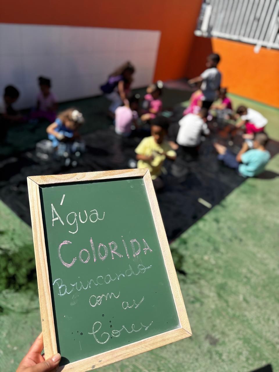 Criança mexendo com águas coloridas